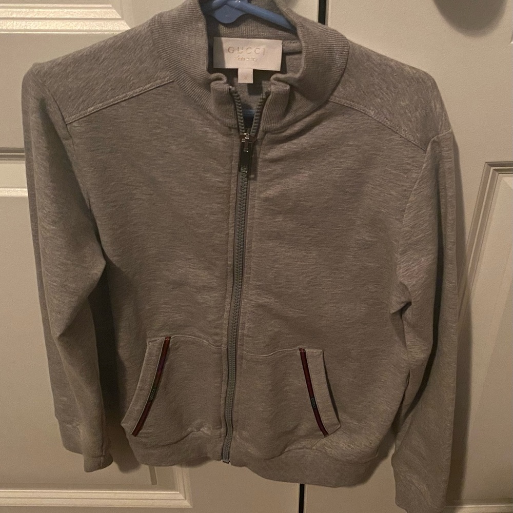 Authentic Gucci boys gray jacket with Signature Gucci red and green at pockets.